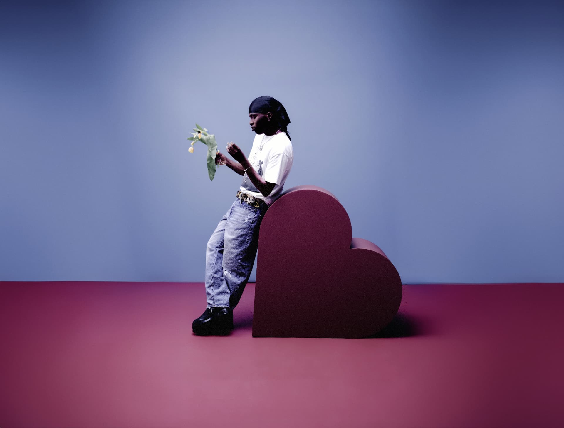 MasterPeace standing beside a sculptural heart