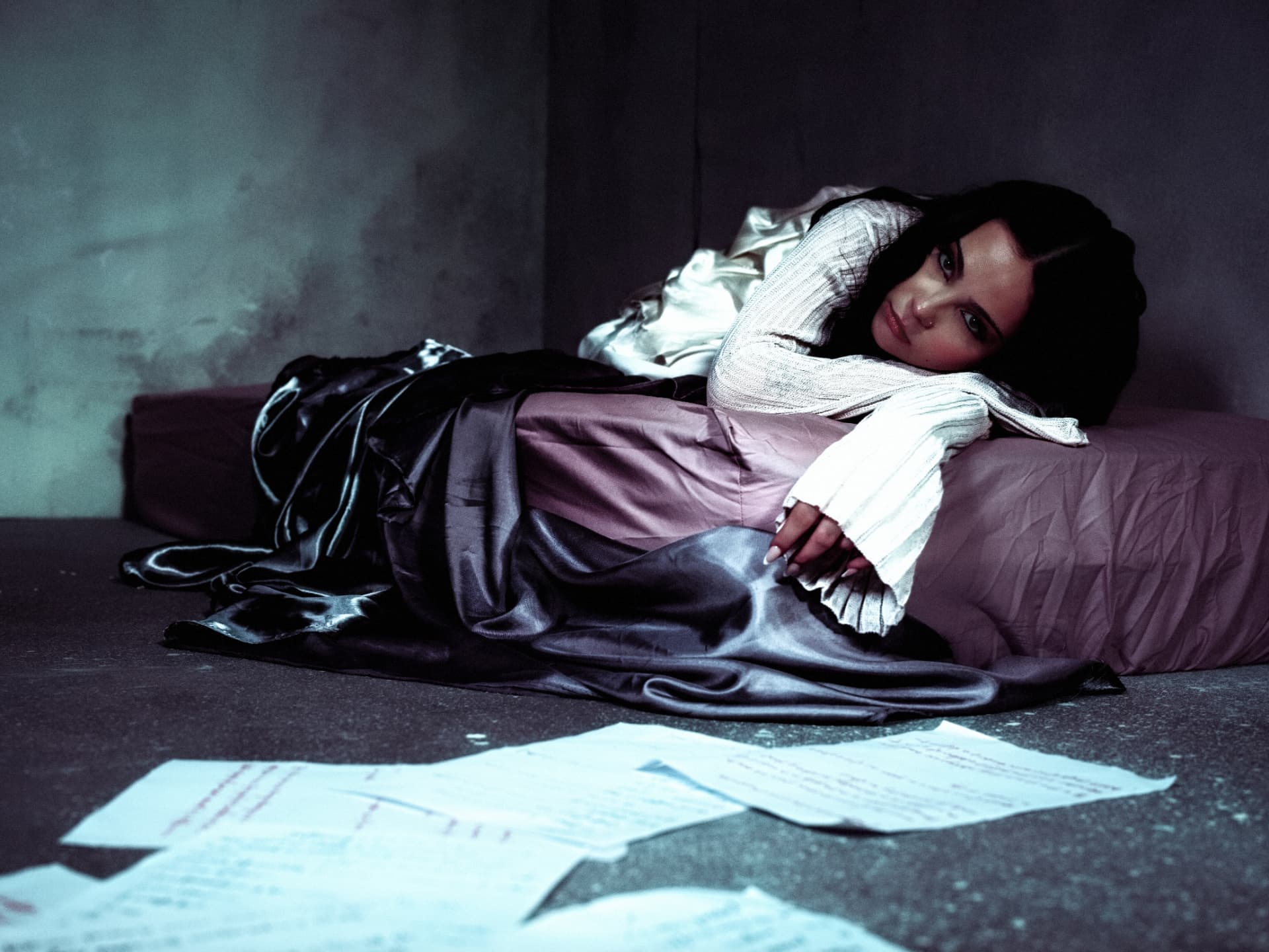 Sabyna reclining beside handwritten pages