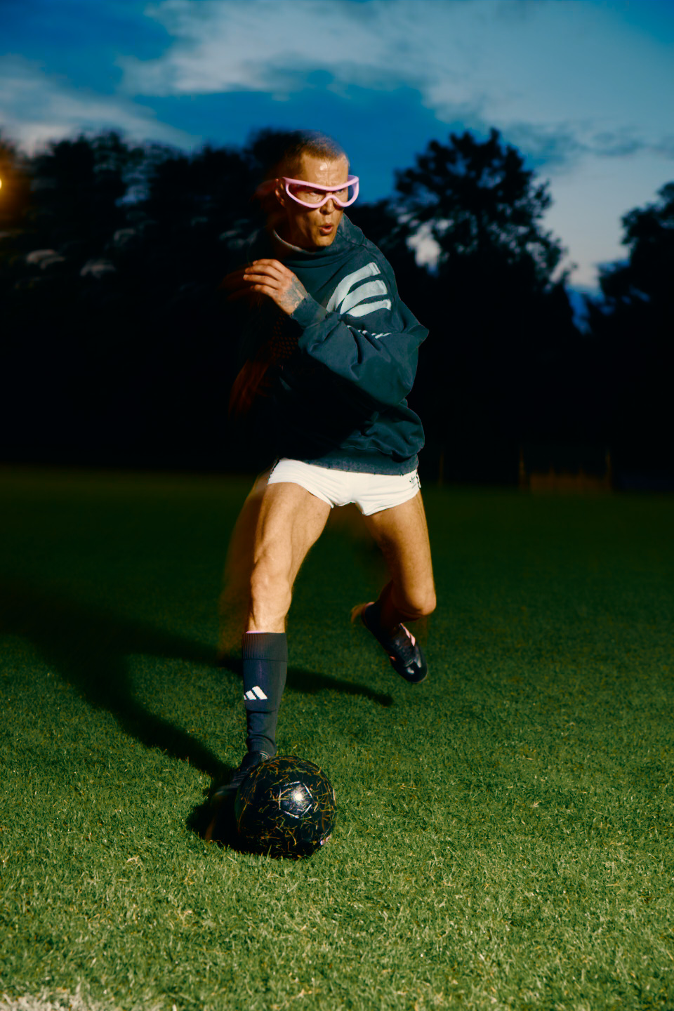 Adidas X Huni — footballer running with the ball