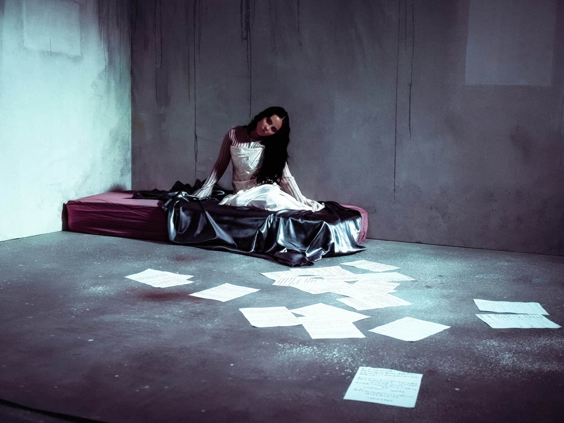 Wide portrait of Sabyna beside scattered pages